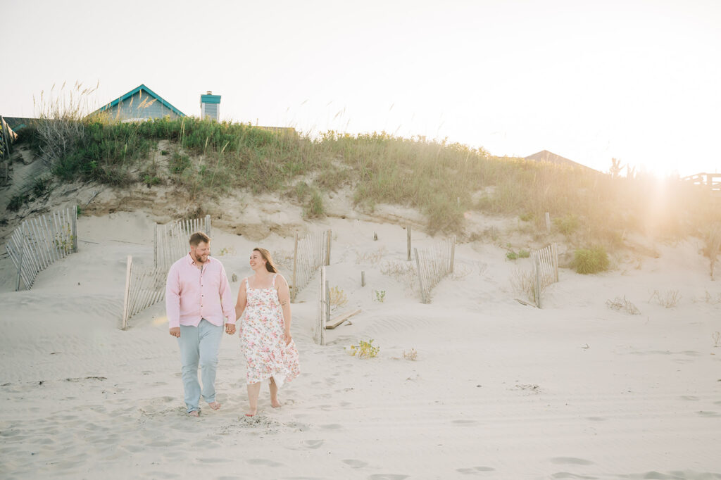 couple walks on beach after proposal