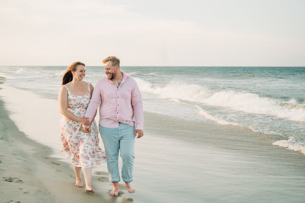 couple walks along water