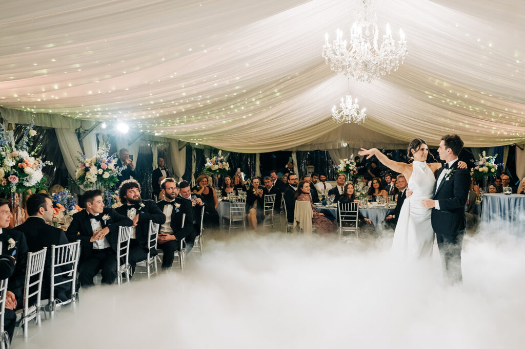 couple dancing at reception with smoke