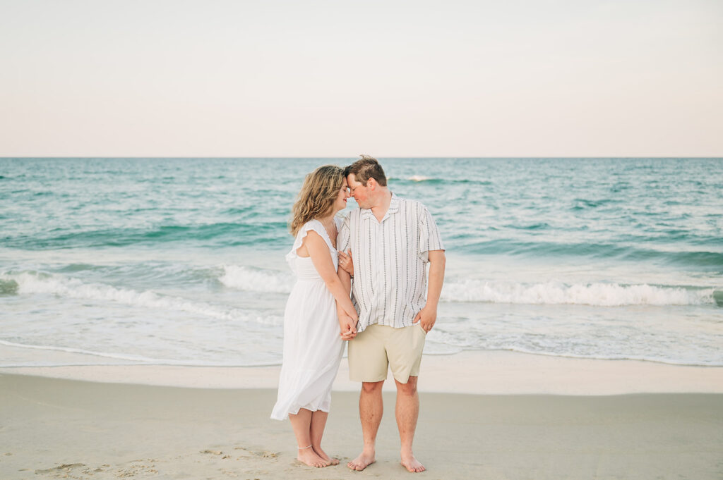 a couple kissing by water in OBX